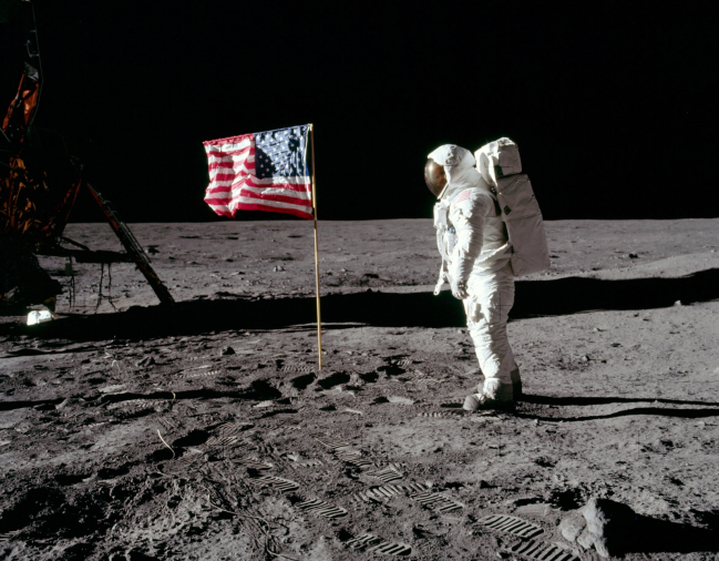 Neil Armstrong and  the American flag on the Moon