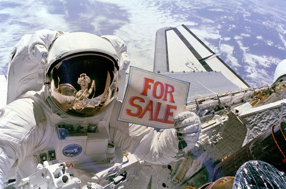 Dale Allan Gardner holding a "For Sale" sign
