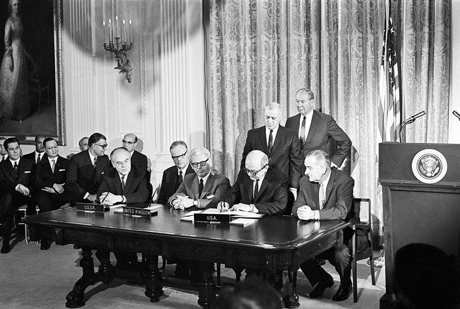 the USSR, Great Britain, and the USA signing the Outer Space Treaty