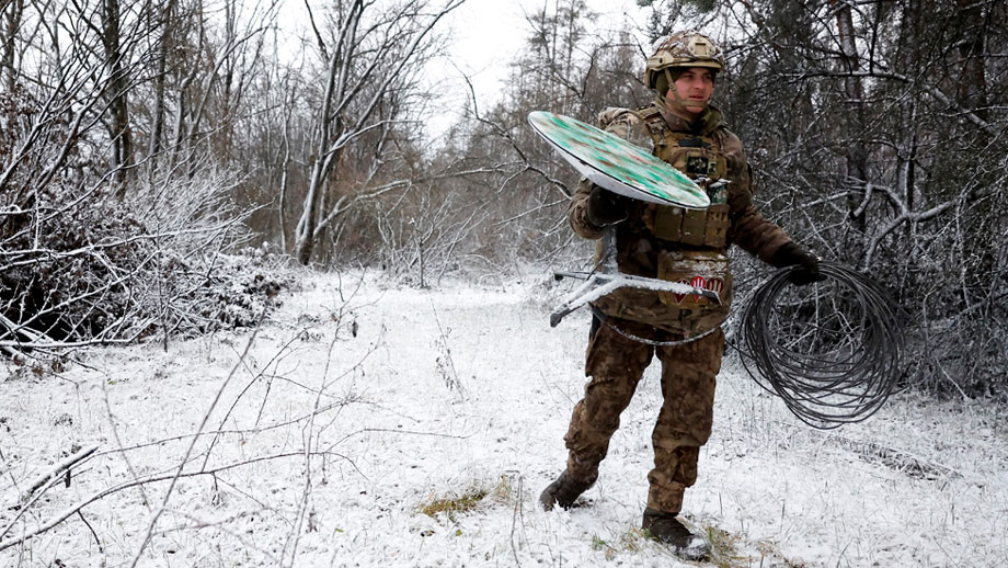 Ukrainian soldier with Starlink receiving terminal